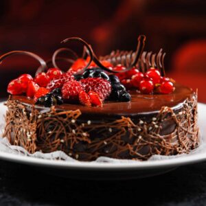 Luscious chocolate cake with fresh berries on a plate