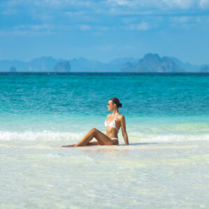 Elegant Woman Relaxing On Bamboo Island Beach In Phi Phi Archipelago, Thailand