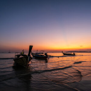 Beautiful sunset sky with long tail boat at Ao Nang beach in Krabi Thailand Beautiful sunset sky with long tail boat at Ao Nang beach in Krabi Thailand
